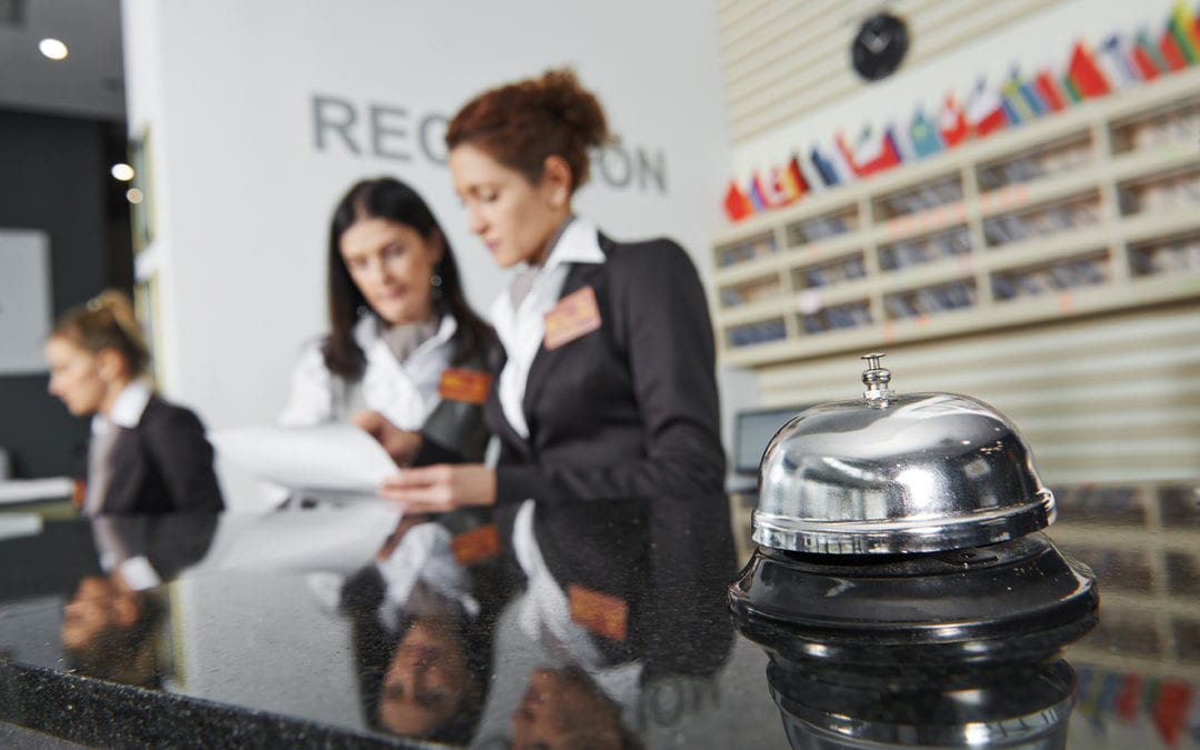 three concierge employees at their desk