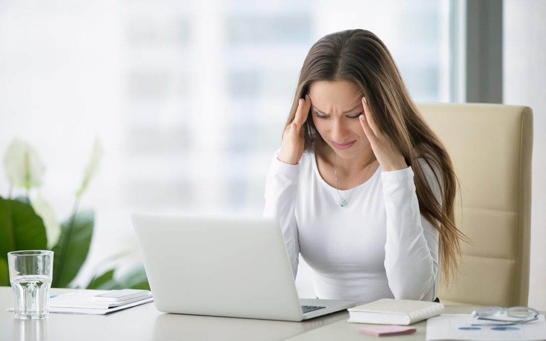 a woman with a headache holding her temples