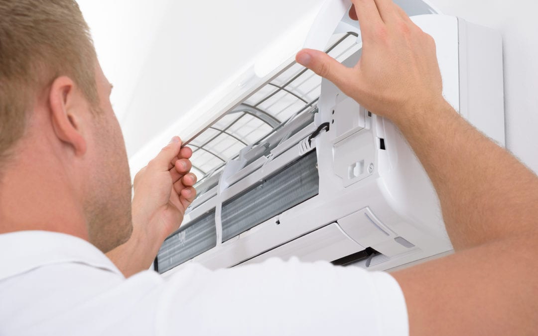 a technician repairing an air conditioner