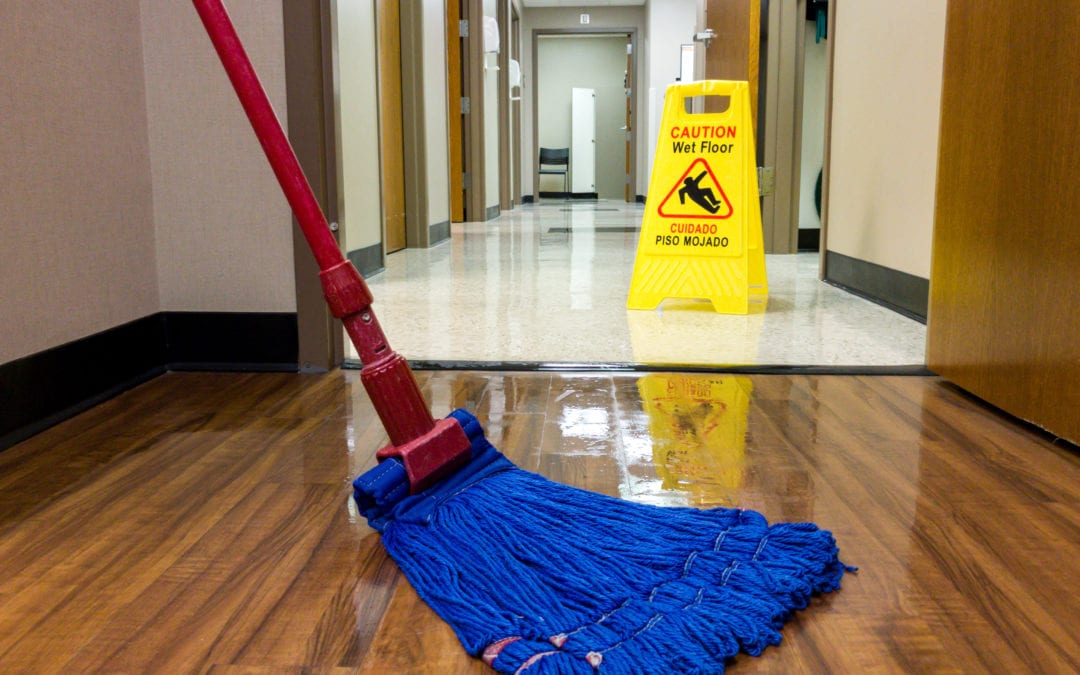 a blue mop on a wood floor