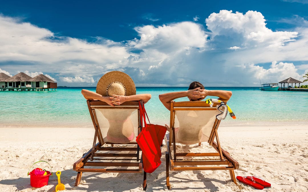 a couple relaxing on a sandy beach