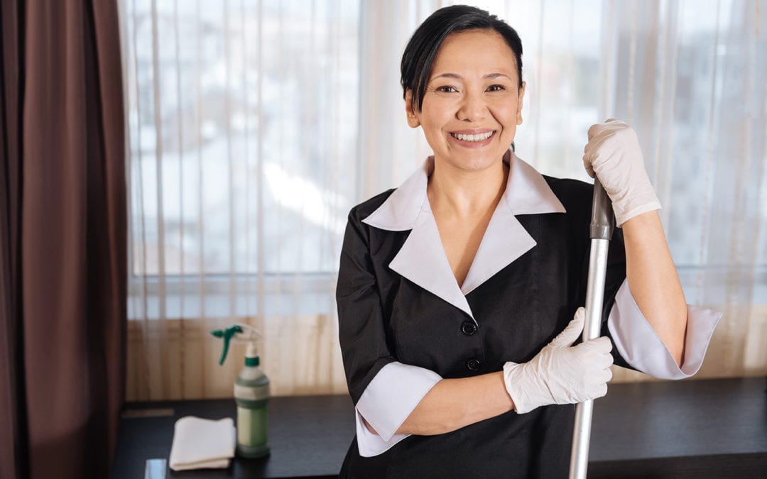 a member of the janitorial staff smiling