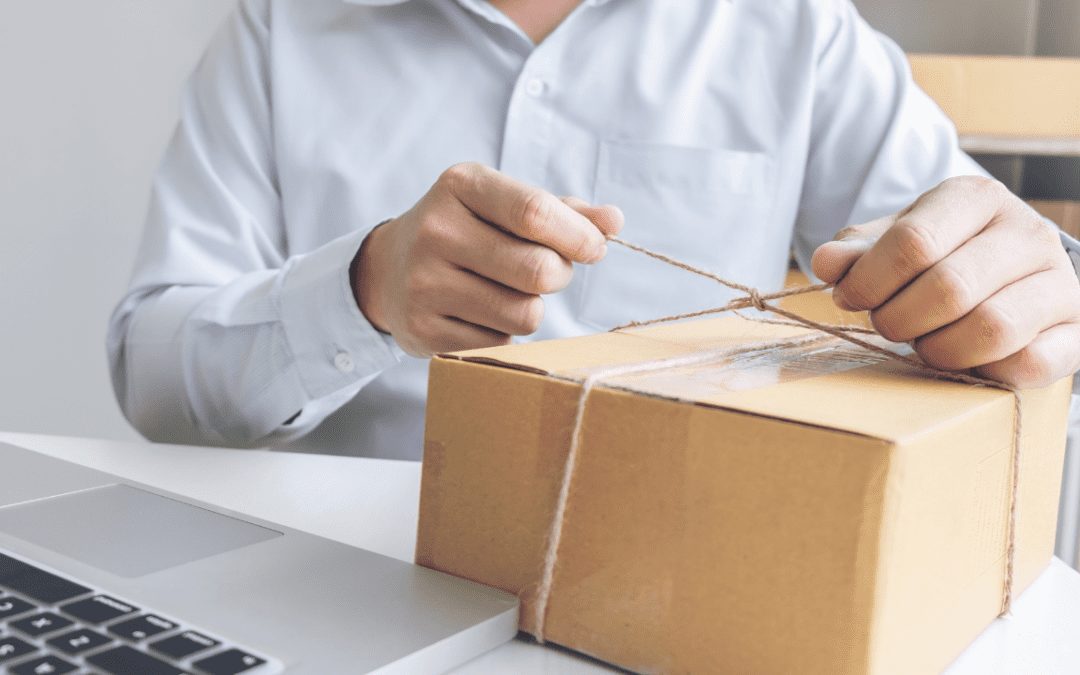 a man tying a string around a box